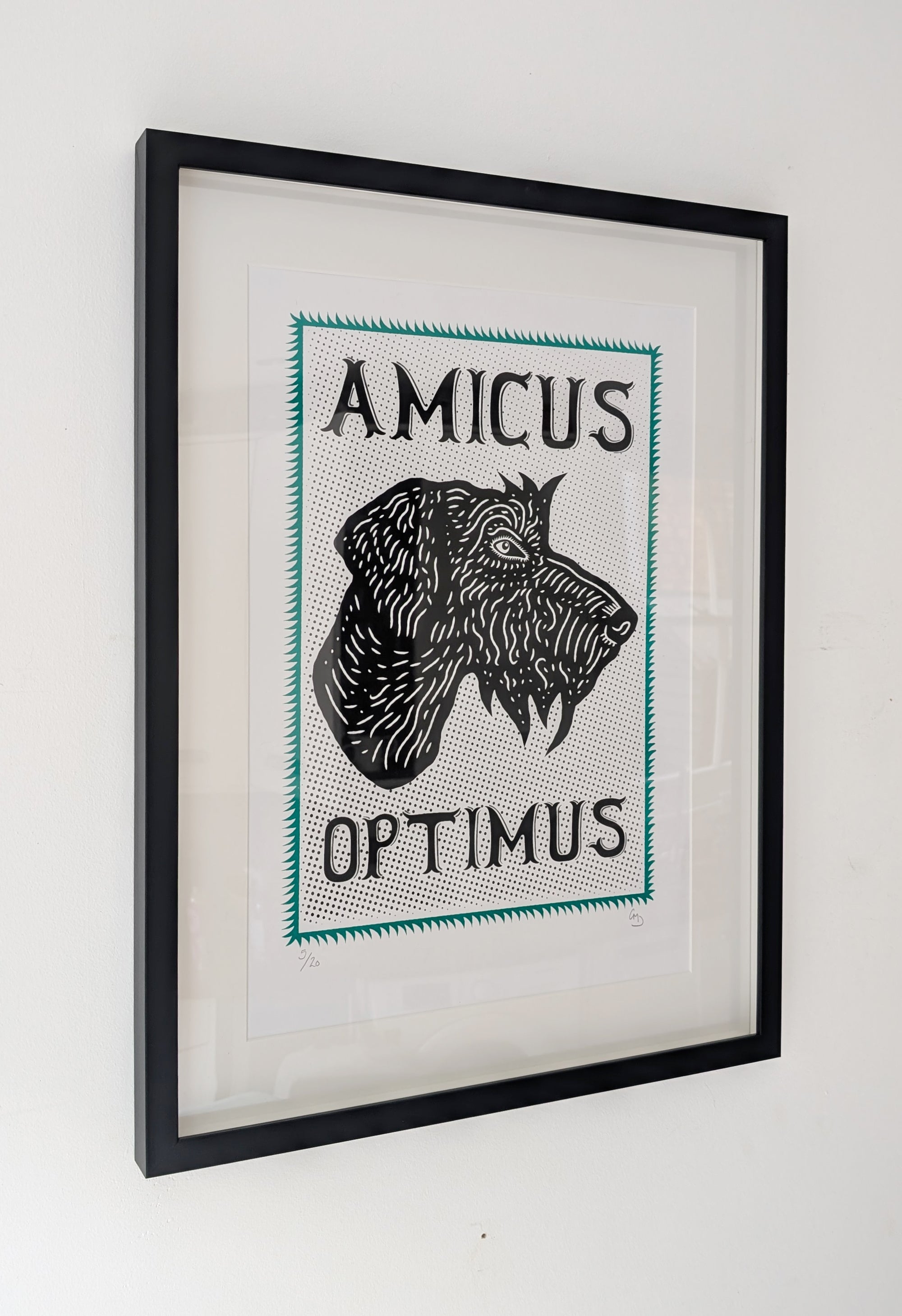 Framed artwork with a dog illustration and text 'AMICUS OPTIMUS' on a white wall.