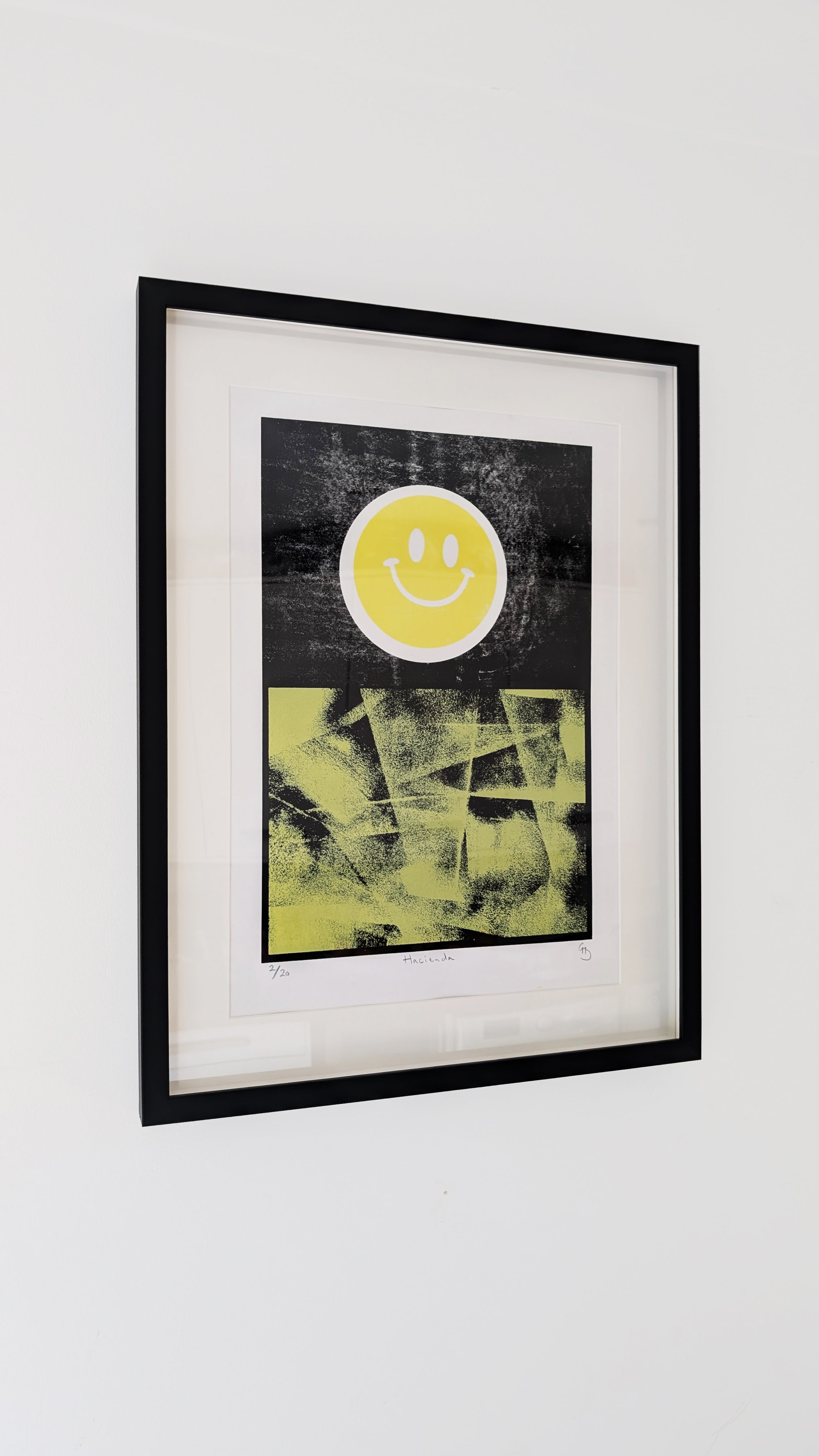 Hacienda framed screen print – yellow smiley rave artwork in black frame by Gerard McDonagh (edition of 20)