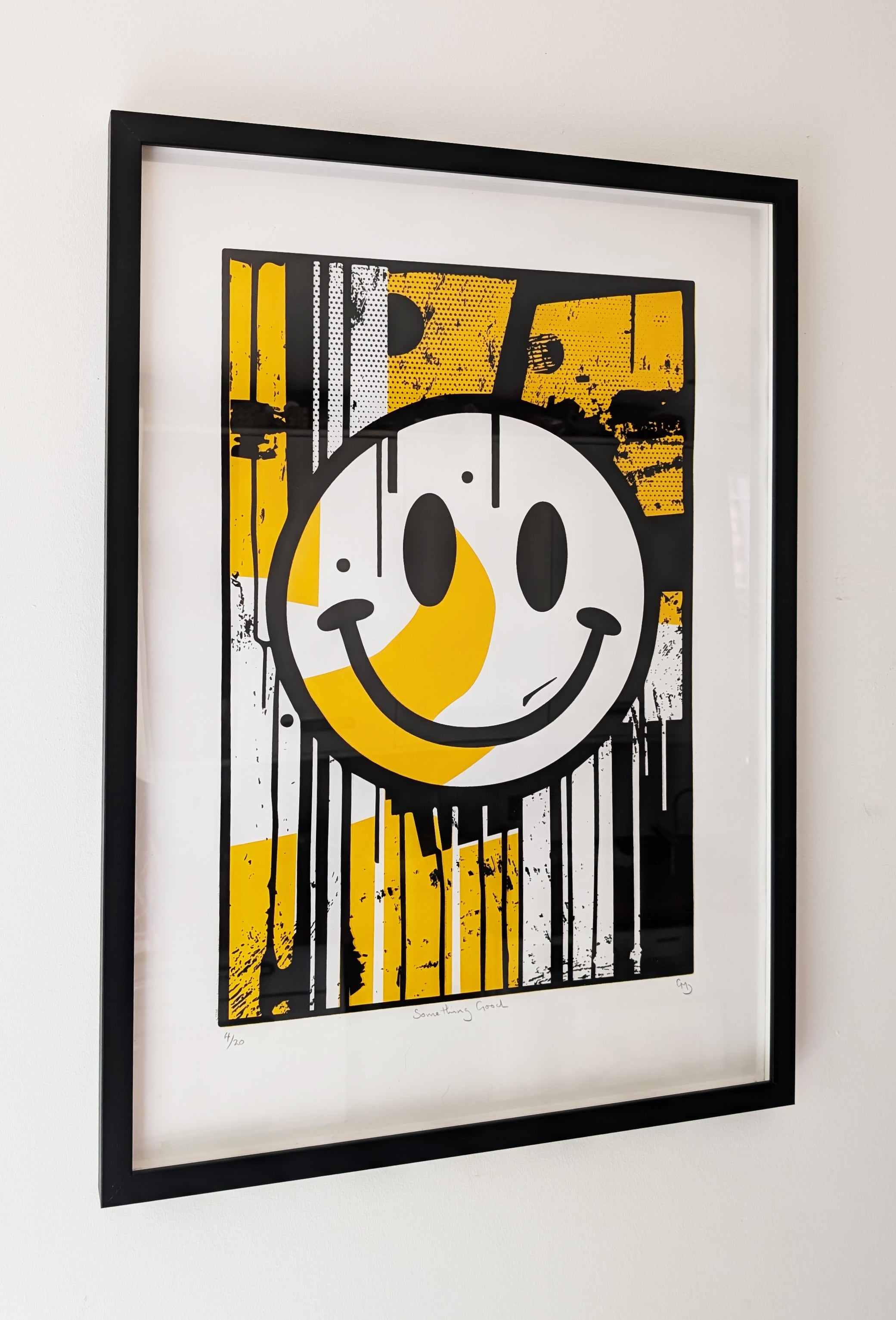 Something Good framed screen print by Gerard McDonagh – bold yellow and black smiley rave artwork in black frame (edition of 20)