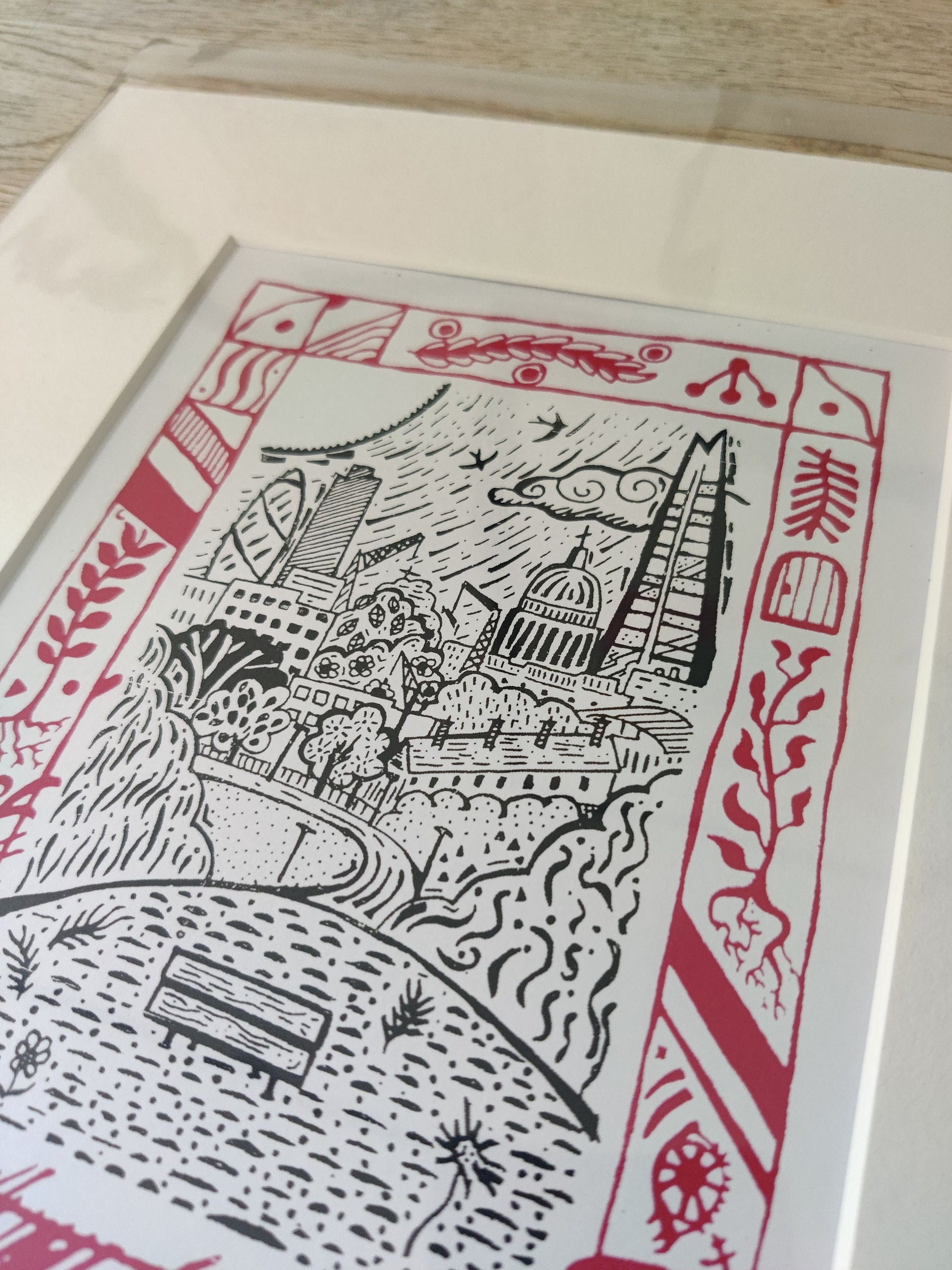 Modern folkloric print showcasing London’s charm from Parliament Hill on Hampstead Heath, framed in vibrant red, seamlessly integrated into the artwork.