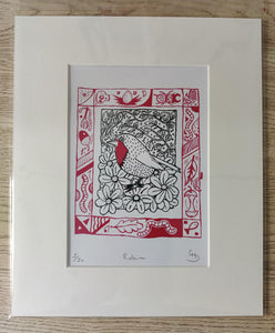 Embark on an artistic journey with our limited edition Robin illustration print by Gerard McDonagh/Bravespear, handcrafted at Print Club in Dalston, East London. Each print captures the essence of nature’s beauty, with the Robin symbolizing renewal amidst lush ivy and vibrant flowers. Available matted and ready to frame or already framed, this piece adds a touch of East London flair to any space.